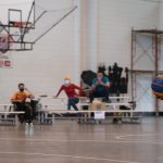 Dynamic wheelchair basketball game showcasing skill and determination indoors.